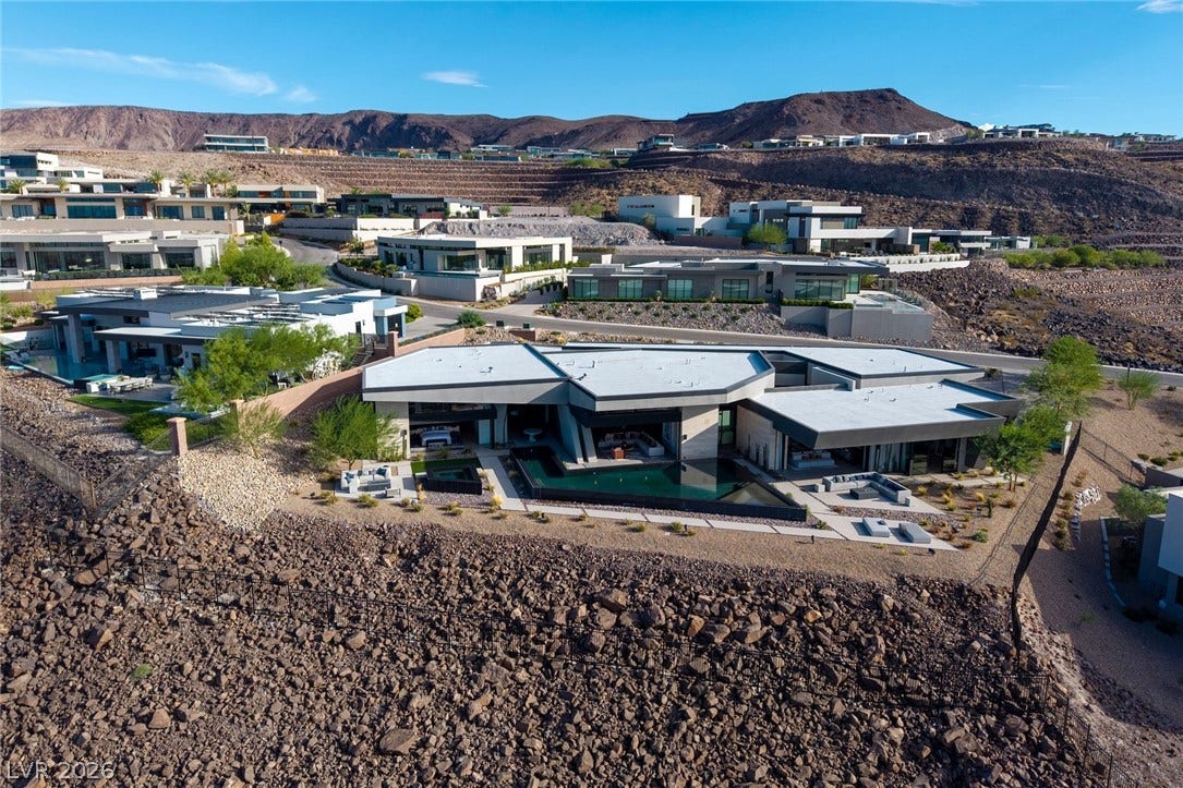 705 Dragon Peak Drive, Henderson, NV 89012 Striking contemporary desert architecture commands attention from an elevated hillside position.