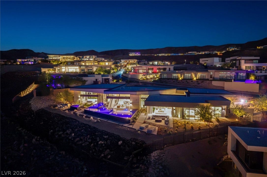 705 Dragon Peak Drive, Henderson, NV 89012 Dramatic desert twilight views frame this architectural masterwork nestled within an exclusive hillside enclave.