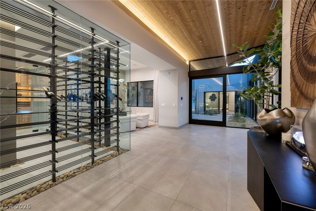 705 Dragon Peak Drive, Henderson, NV 89012 Striking wood plank ceilings and large format tile flooring define this architectural transition space.