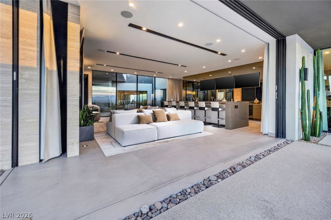 705 Dragon Peak Drive, Henderson, NV 89012 Seamless indoor-outdoor living flows effortlessly from the tiled patio into a modern entertainment room.
