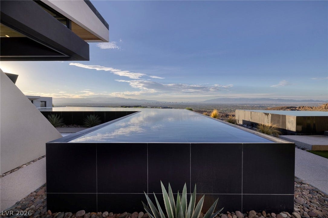 705 Dragon Peak Drive, Henderson, NV 89012 An architectural infinity pool projects toward sweeping desert views under a clear sky.