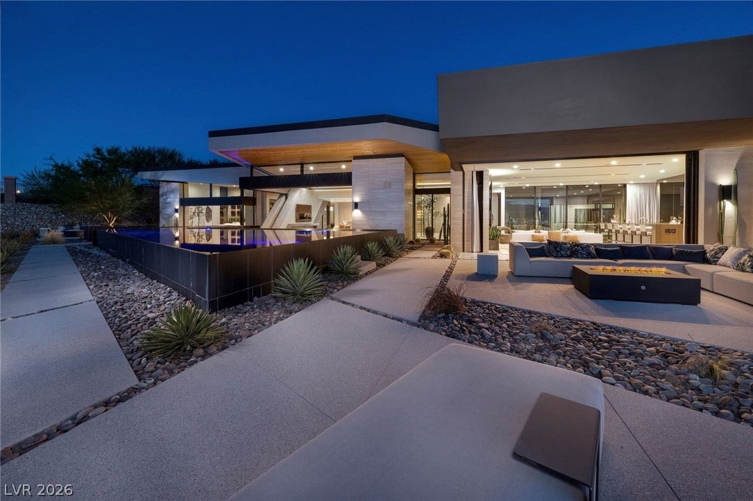 705 Dragon Peak Drive, Henderson, NV 89012 Concrete walkways lead past a sleek infinity pool to expansive outdoor living spaces.