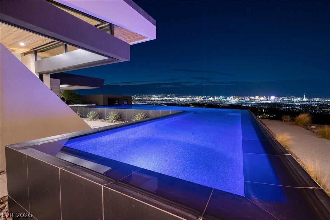 705 Dragon Peak Drive, Henderson, NV 89012 Dramatic modern architecture frames a glistening pool overlooking panoramic city lights.