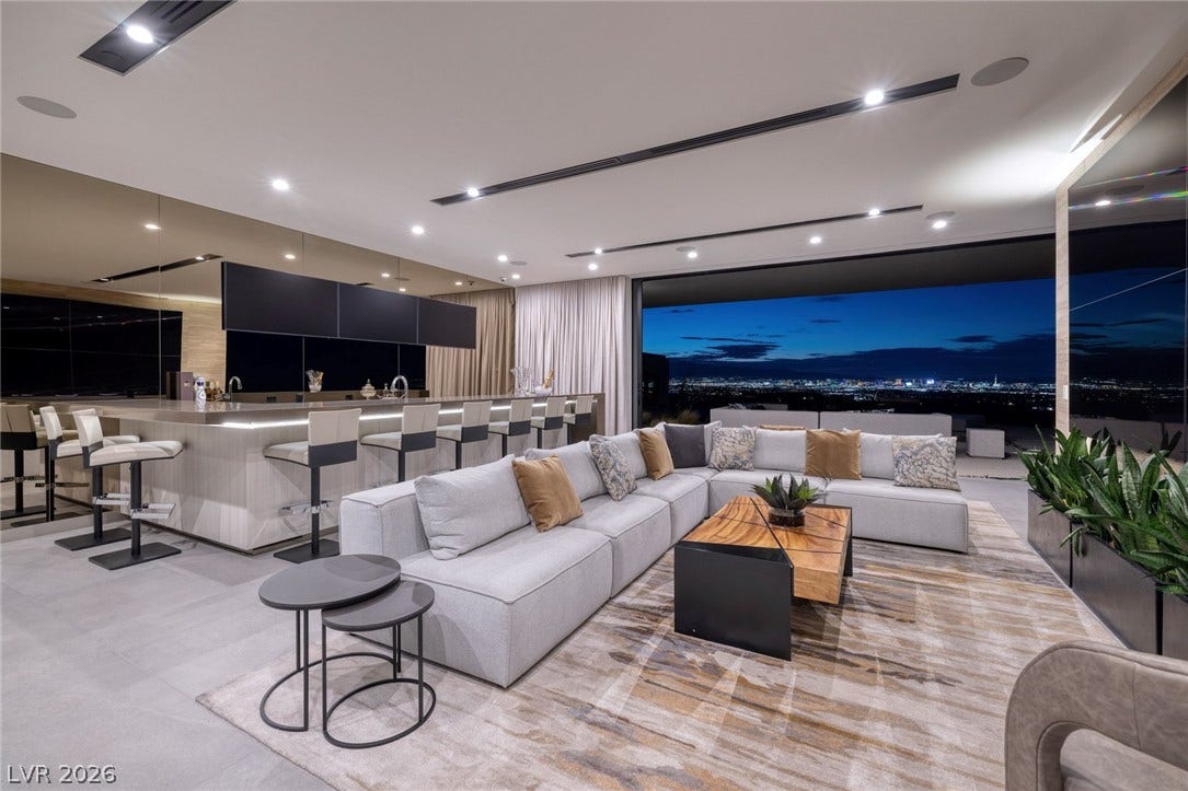 705 Dragon Peak Drive, Henderson, NV 89012 Gleaming tile floors anchor an airy open living space frames twinkling city lights.