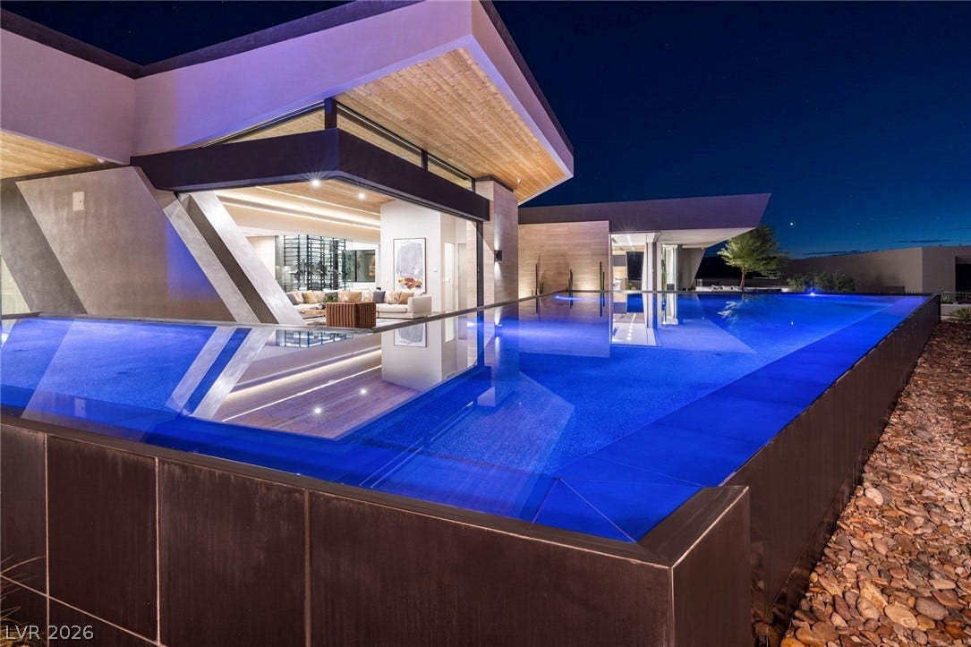 705 Dragon Peak Drive, Henderson, NV 89012 Dramatic modern architecture seamlessly integrates an infinity-edge pool with sleek indoor-outdoor living spaces.