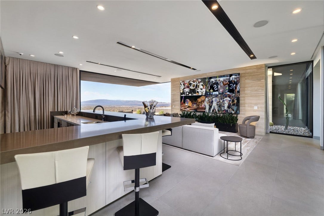 705 Dragon Peak Drive, Henderson, NV 89012 Clean lines and stone flooring define this modern space showcasing sweeping mountain views.