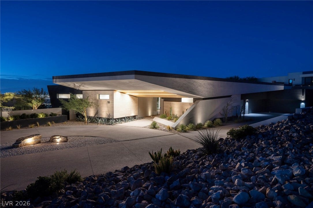 705 Dragon Peak Drive, Henderson, NV 89012 Dramatic architectural lines and custom lighting define this modern desert estate entrance.