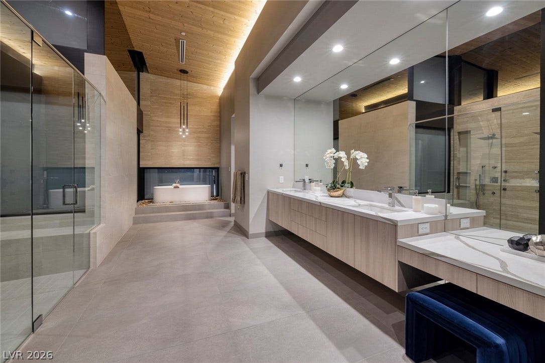 705 Dragon Peak Drive, Henderson, NV 89012 A floating vanity and large walk-in shower complement the wood ceiling in this modern bathroom.