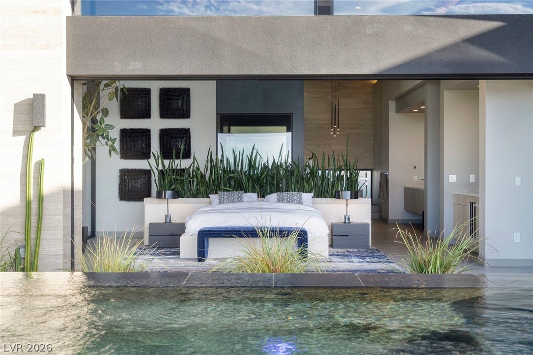 705 Dragon Peak Drive, Henderson, NV 89012 Retractable glass walls merge this luxury bedroom suite with the sparkling outdoor pool.