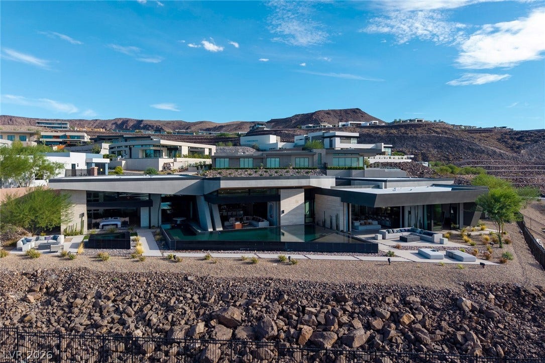 705 Dragon Peak Drive, Henderson, NV 89012 Dramatic modern architecture commands attention against a rugged desert mountain backdrop.