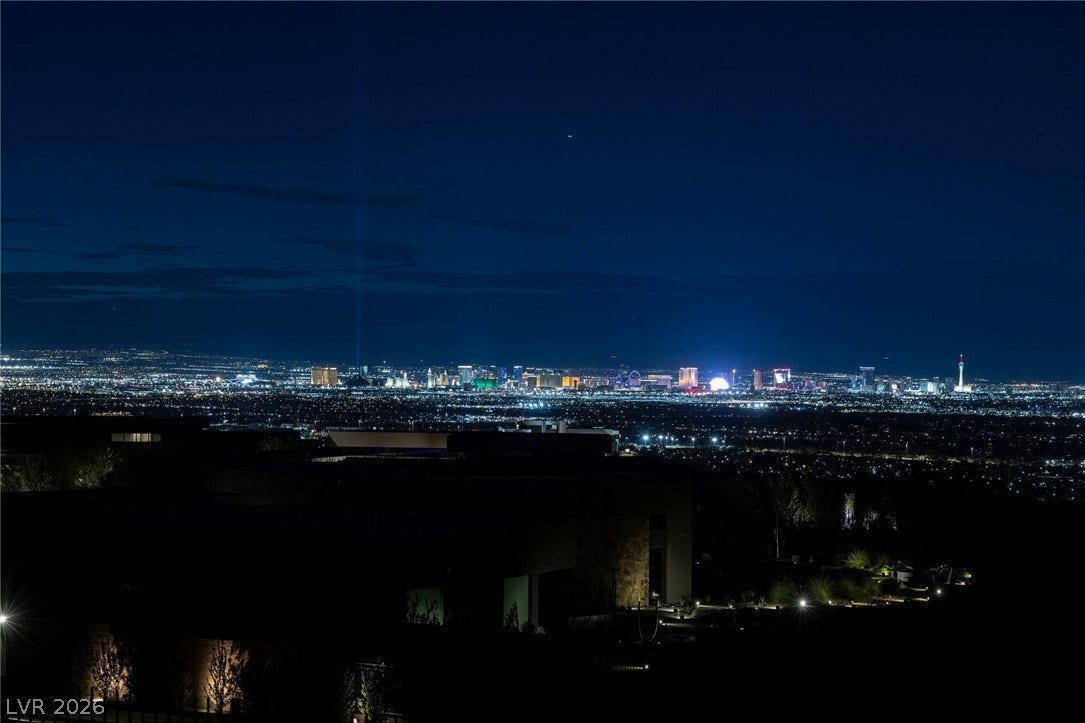 705 Dragon Peak Drive, Henderson, NV 89012 A sweeping panorama captures brilliant city lights shining across the valley at night.