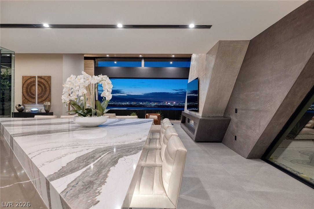 705 Dragon Peak Drive, Henderson, NV 89012 Dramatic architectural angles framing far-reaching city lights views through seamless glass walls.