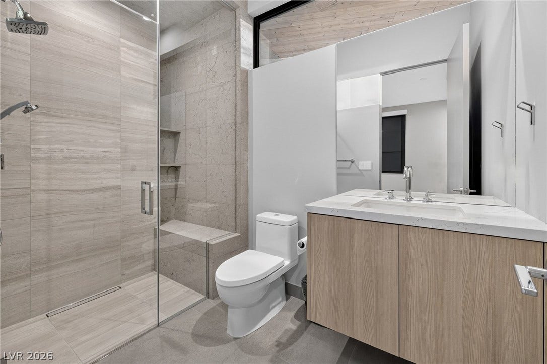 705 Dragon Peak Drive, Henderson, NV 89012 Clean lines and large-format tiling define this contemporary washroom.