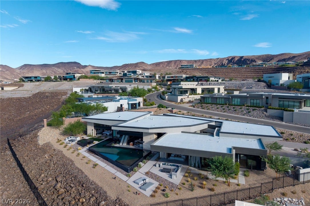 705 Dragon Peak Drive, Henderson, NV 89012 Striking contemporary architecture integrates seamlessly into the rugged desert hillside landscape.