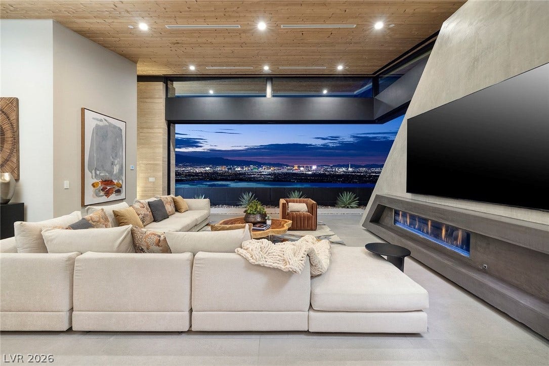 705 Dragon Peak Drive, Henderson, NV 89012 Gleaming city lights frame this modern living space anchored by a sleek linear fireplace.