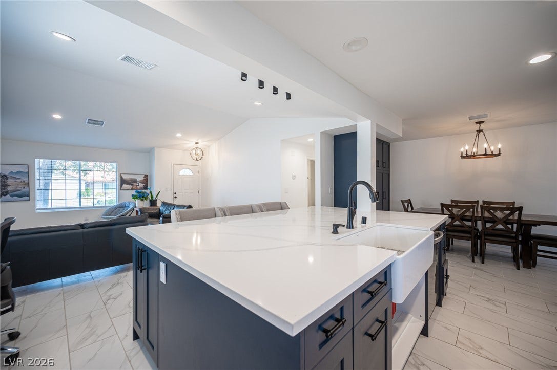 3139 Regal Oak Drive, Henderson, NV 89014 An expansive kitchen island with stone counters anchors the open floorplan.