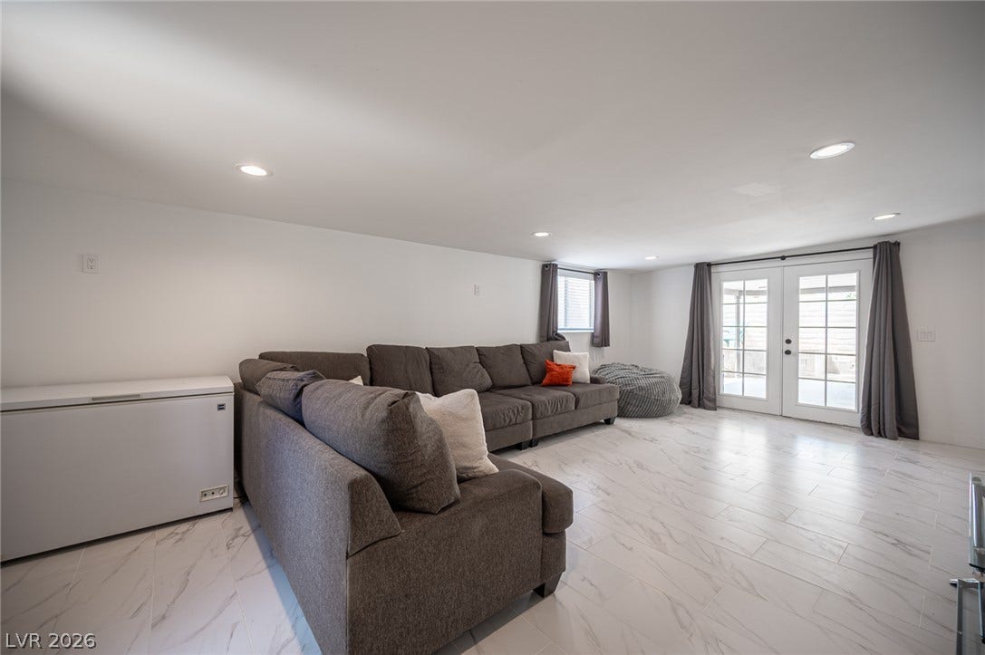 3139 Regal Oak Drive, Henderson, NV 89014 Polished tile flooring and recessed lighting define this spacious living area with outdoor access.