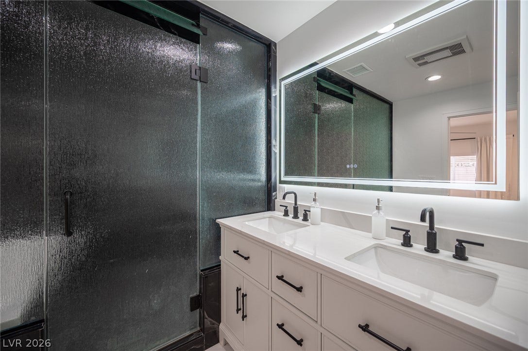 3139 Regal Oak Drive, Henderson, NV 89014 A contemporary double vanity pairs with a textured glass walk-in shower.