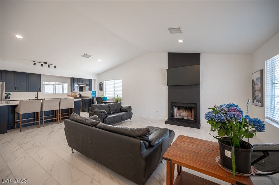 3139 Regal Oak Drive, Henderson, NV 89014 Gleaming tile floors and vaulted ceilings elevate this open-concept main living area.