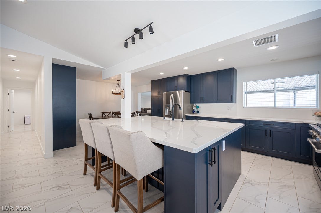 3139 Regal Oak Drive, Henderson, NV 89014 An expansive kitchen island with stone counters anchors this modern culinary space.