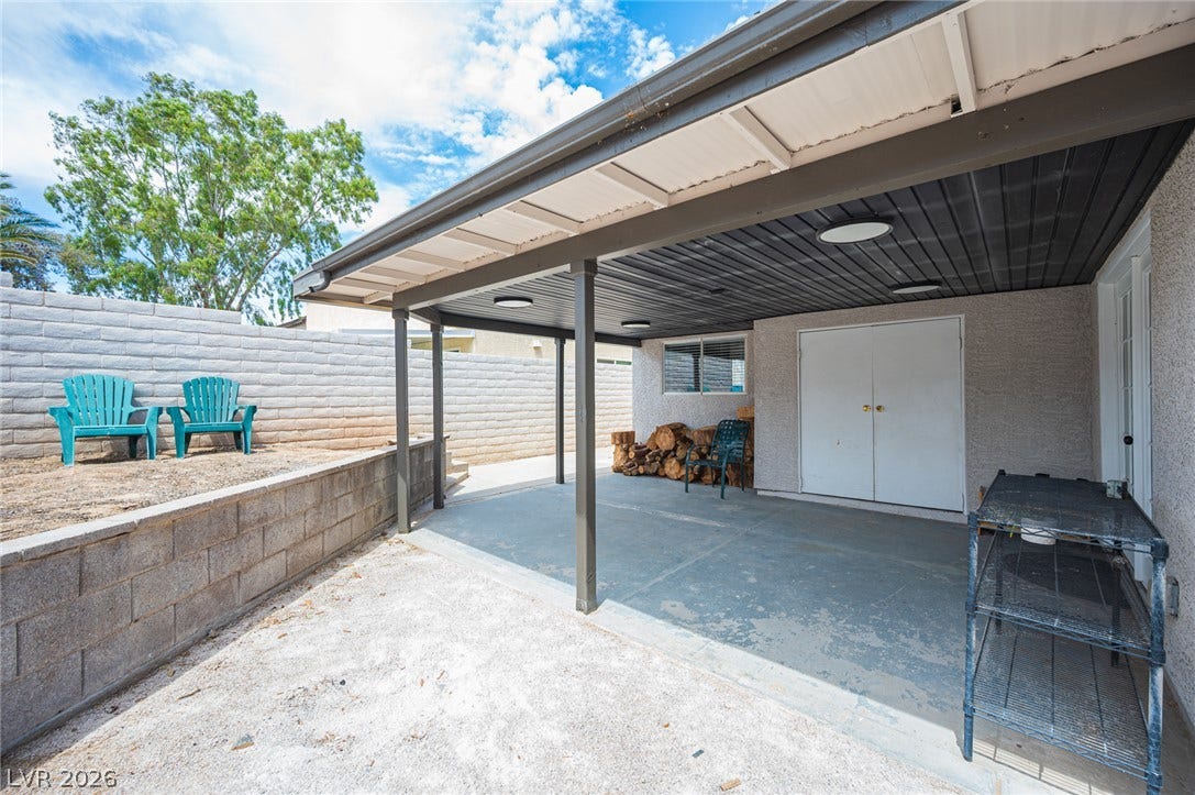 3139 Regal Oak Drive, Henderson, NV 89014 A sheltered concrete patio offers comfortable outdoor space alongside a raised yard area.
