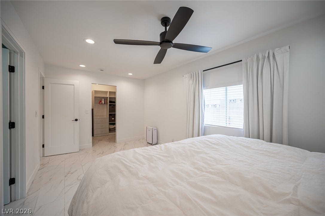 3139 Regal Oak Drive, Henderson, NV 89014 Polished tile flooring and recessed lighting define this spacious bedroom suite.