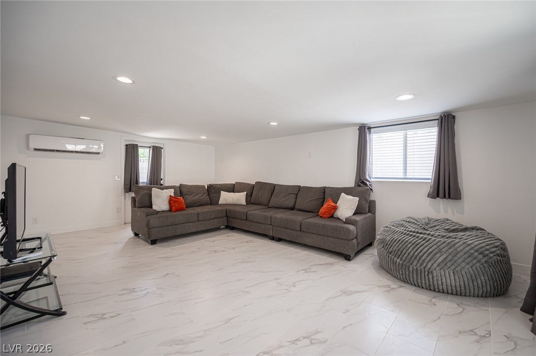 3139 Regal Oak Drive, Henderson, NV 89014 Gleaming stone-look floors and sleek recessed lighting define this versatile living space.