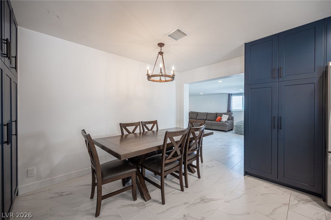 3139 Regal Oak Drive, Henderson, NV 89014 An open floorplan seamlessly connects the dining space with modern tile flooring to the living room.
