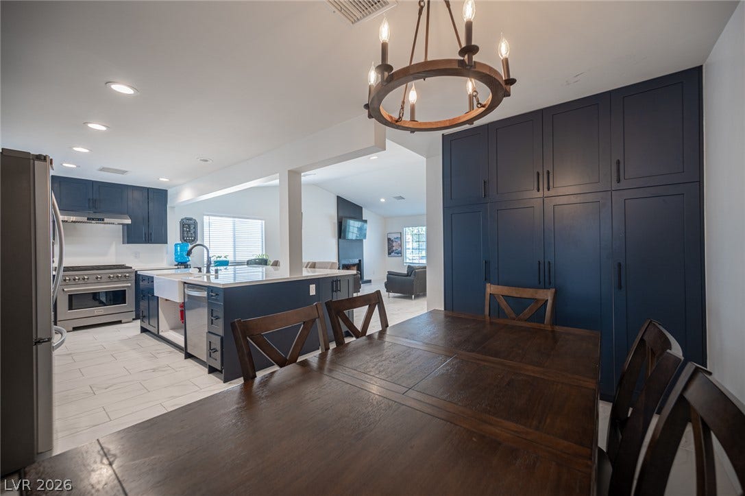 3139 Regal Oak Drive, Henderson, NV 89014 Gleaming floors and custom cabinetry anchor this integrated dining area and modern kitchen.