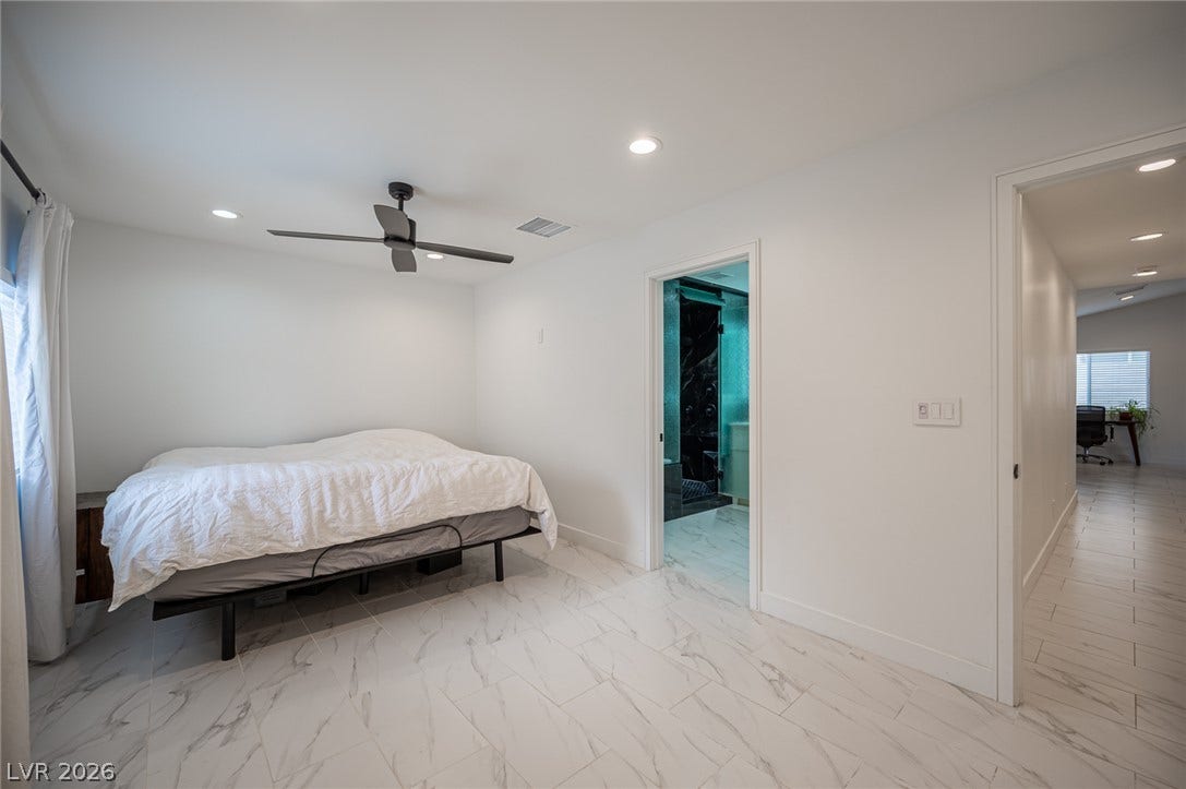 3139 Regal Oak Drive, Henderson, NV 89014 Polished tile flooring flows seamlessly through this modern bedroom with recessed lighting.