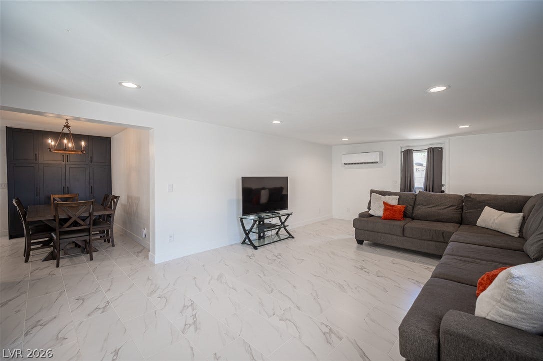 3139 Regal Oak Drive, Henderson, NV 89014 Polished tile flooring flows seamlessly through this open-concept living area and adjacent dining space.