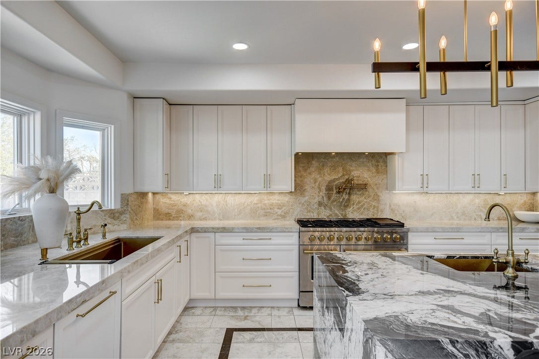 Gleaming stone countertops and matching tiled floors define this classic culinary workspace.