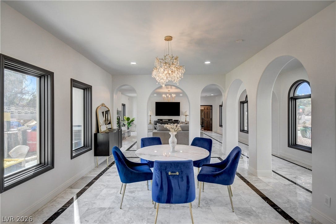 Gleaming marble floors and elegant arched entryways define this sophisticated dining space.