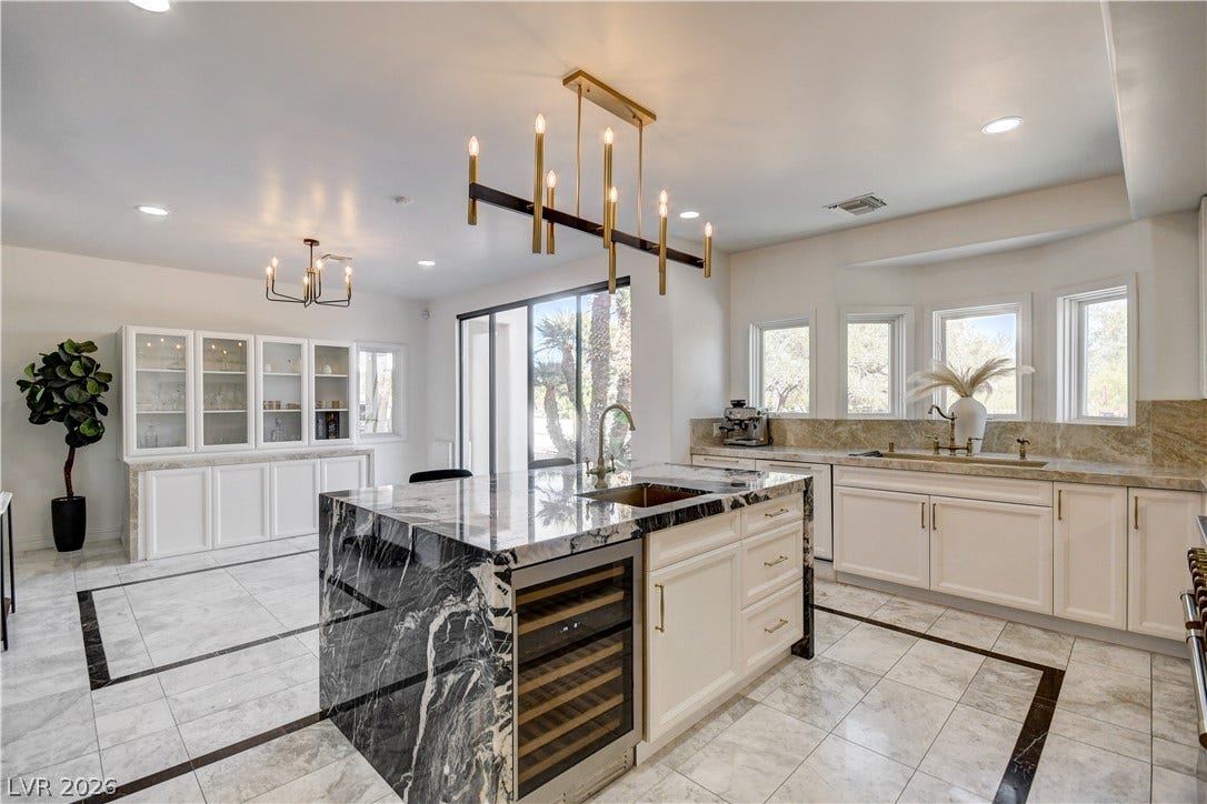 Polished tile flooring and premium stone countertops elevate this culinary workspace.