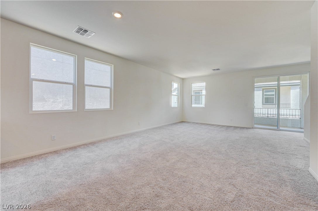 Plush carpeting and multiple windows create a comfortable and open living space.