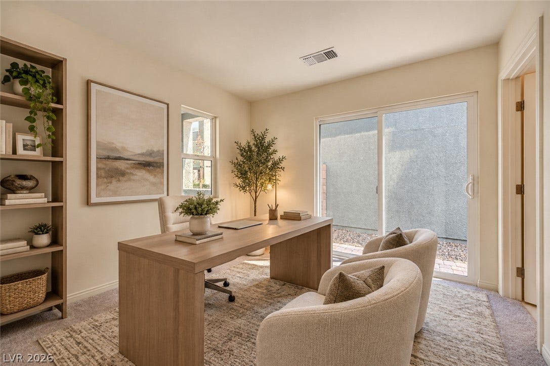 Sliding glass doors open directly to the outdoors from this quiet workspace.
