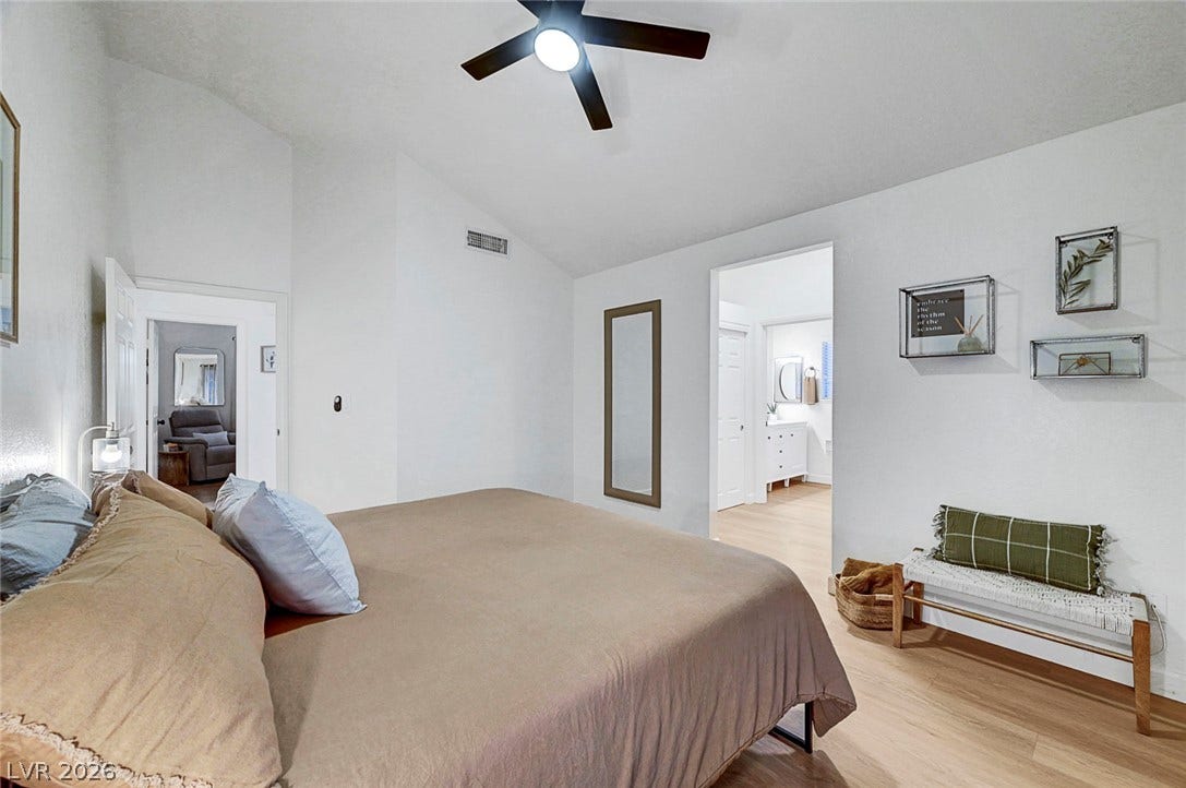 Vaulted ceilings and warm wood floors elevate this peaceful master bedroom retreat.