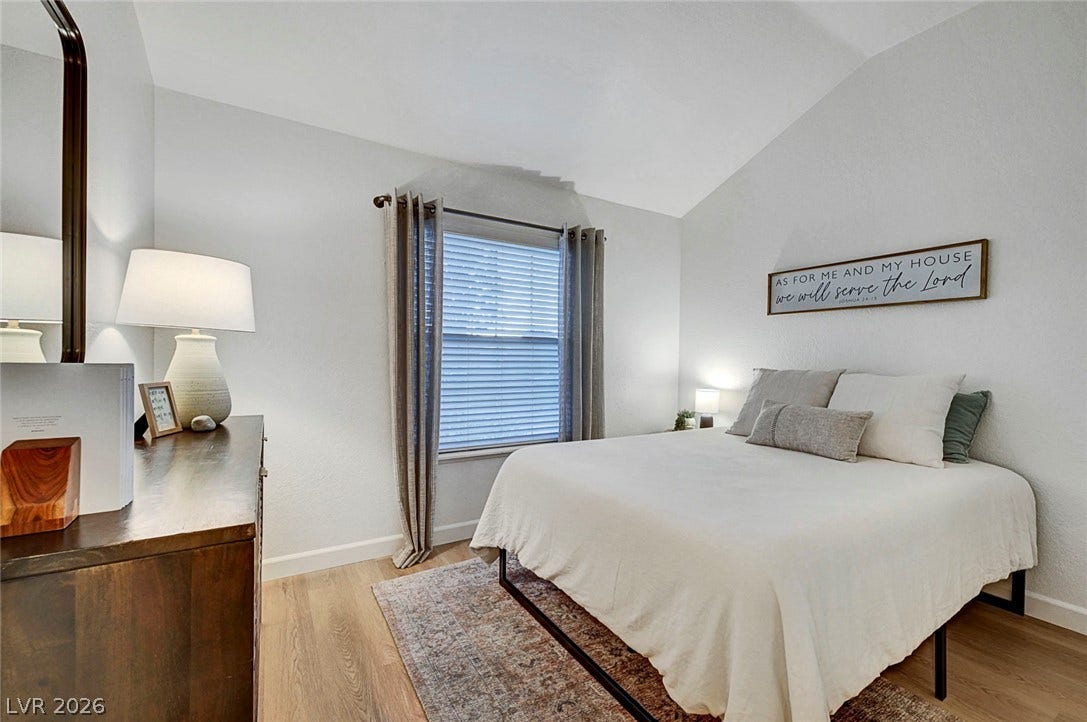 Vaulted ceilings and warm wood floors define this peaceful sleeping space.