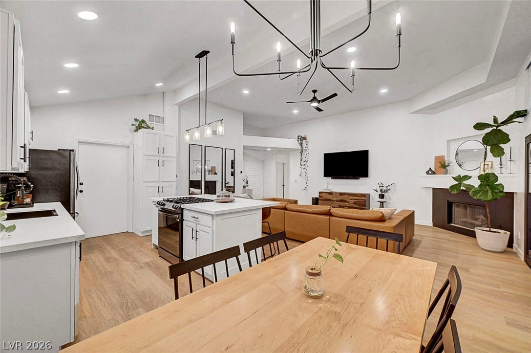 An airy open concept layout connects the dining space, kitchen, and living area seamlessly.