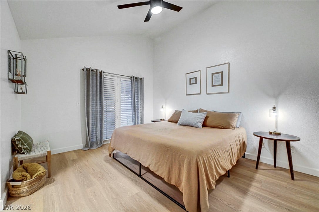 Vaulted ceilings and warm wood floors define this tranquil bedroom space.