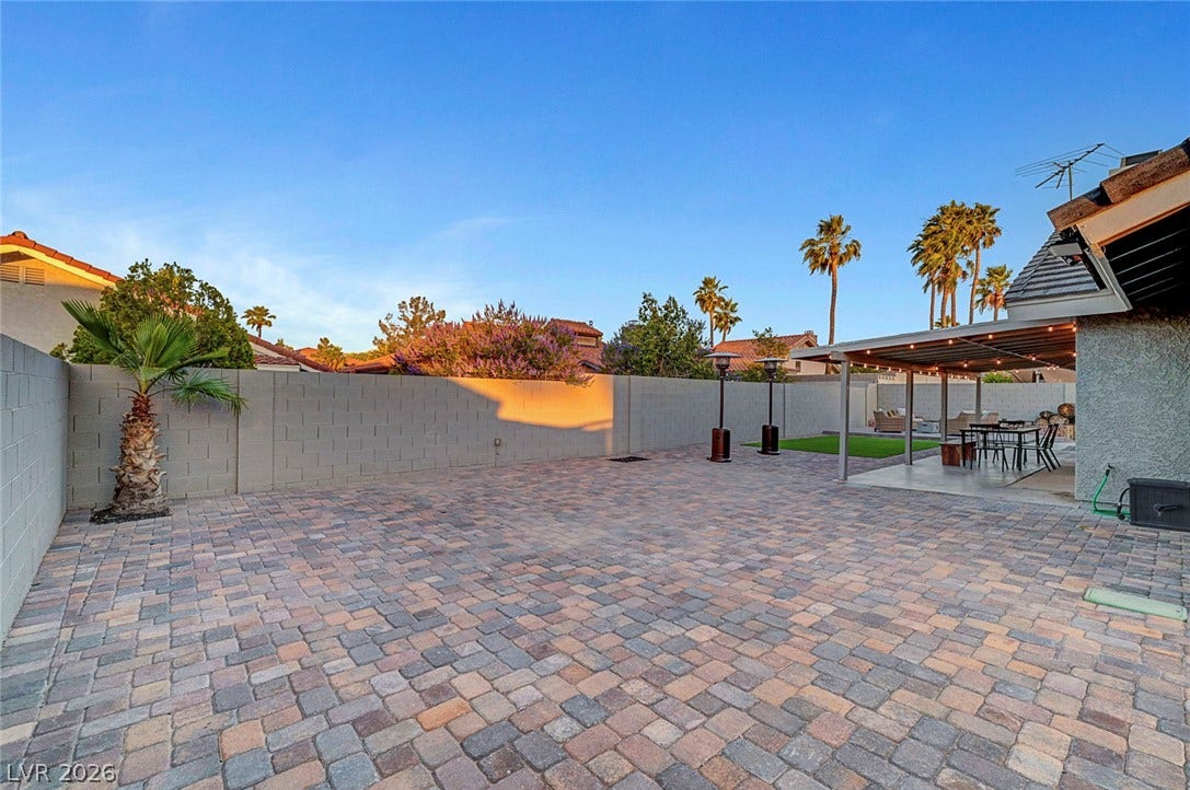 Expansive paver patio areas offer ample space for outdoor dining and entertaining.