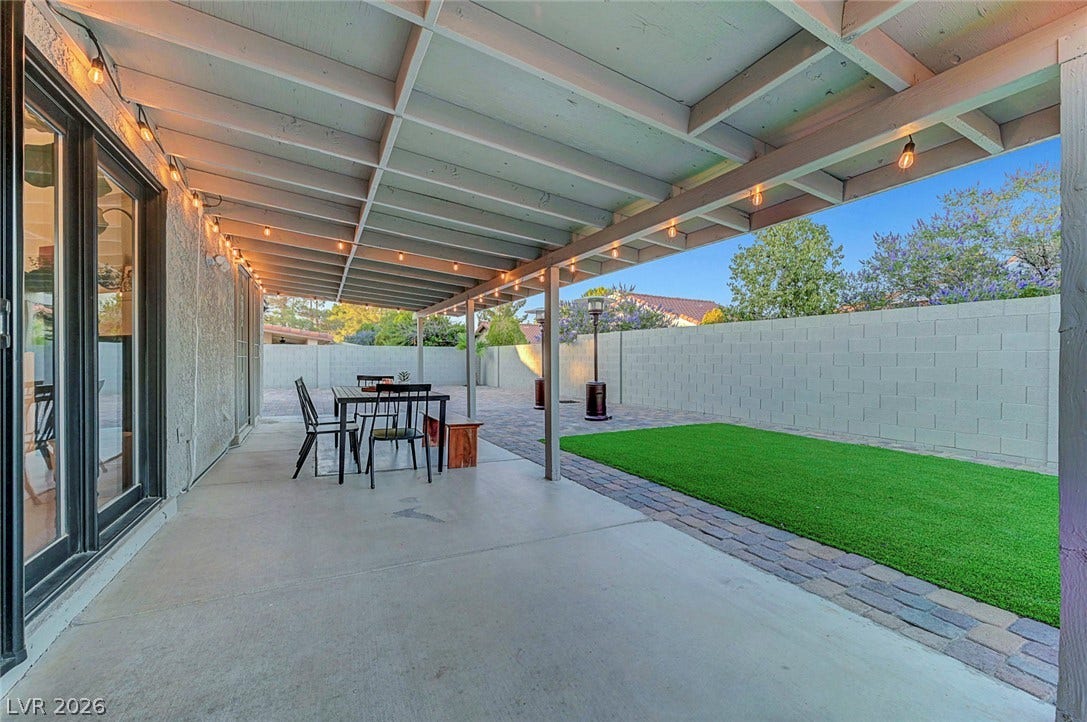 A spacious covered patio provides the perfect setting for outdoor relaxation and entertaining.