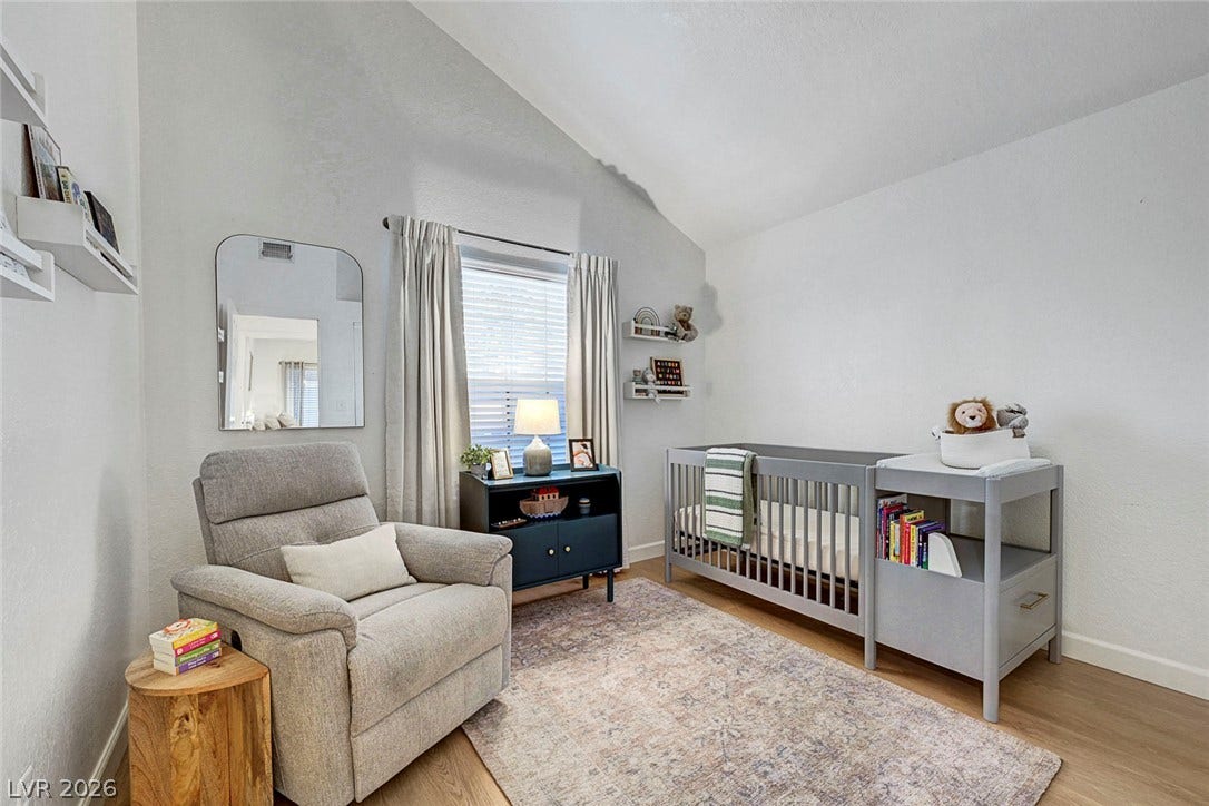 High vaulted ceilings and wood floors define this bright nursery space.