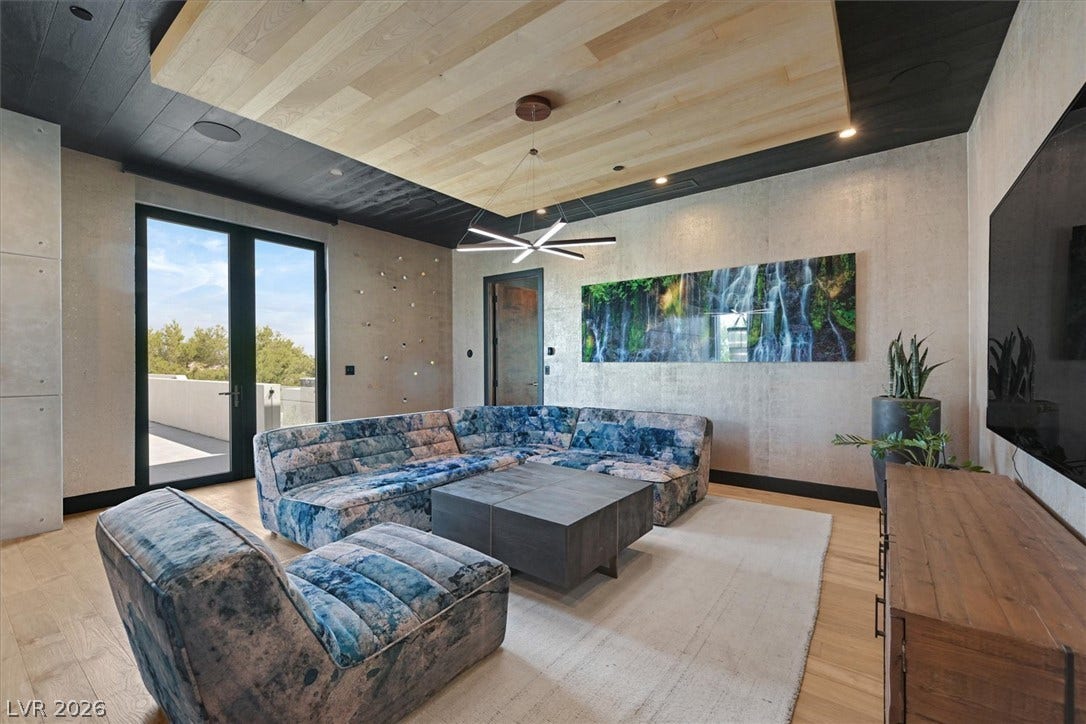 4155 Badura Avenue, Las Vegas, NV 89118 Striking architectural details define this modern living space framed by warm wood flooring.