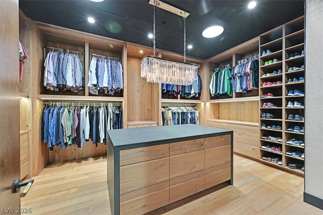 4155 Badura Avenue, Las Vegas, NV 89118 Rich wood cabinetry and a central island highlight this custom walk-in closet space.
