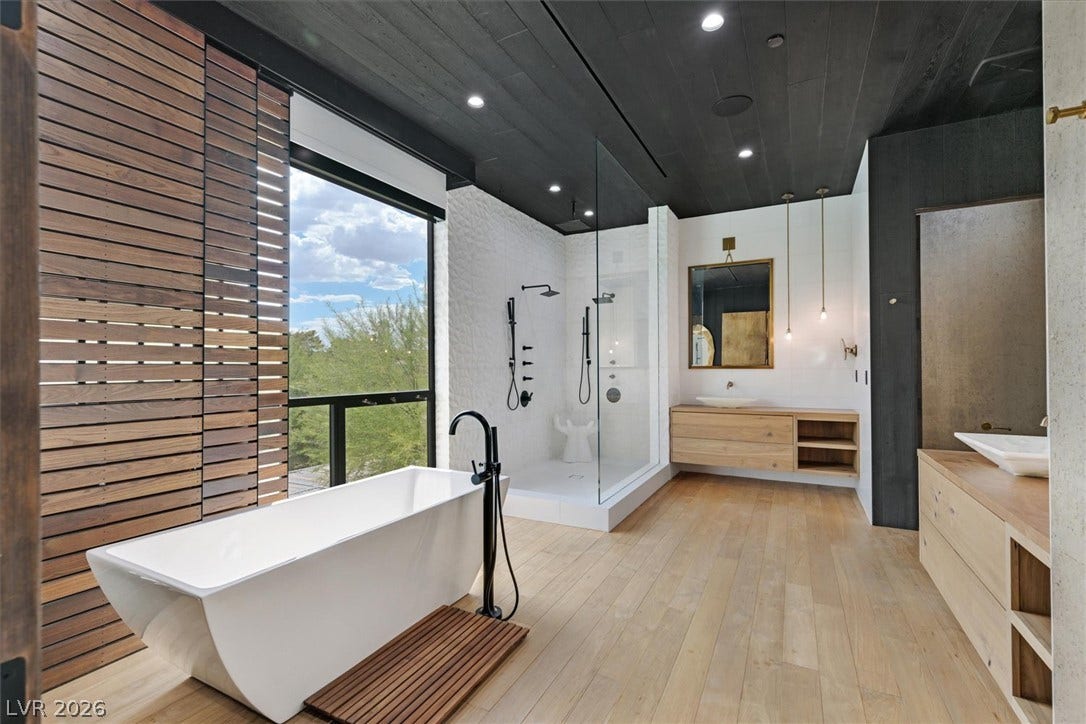 4155 Badura Avenue, Las Vegas, NV 89118 Rich wood plank ceilings and matching floors frame this modern bath with a freestanding tub.