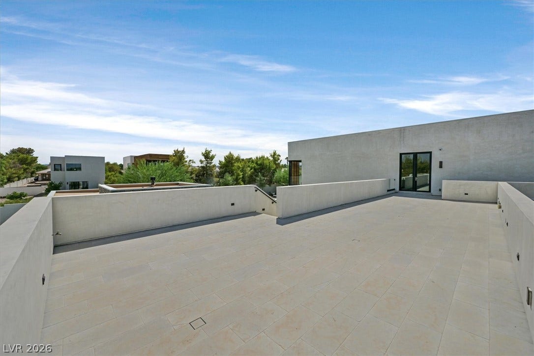 4155 Badura Avenue, Las Vegas, NV 89118 A spacious rooftop terrace offers tiled flooring, sleek modern walls, and distant neighborhood views.