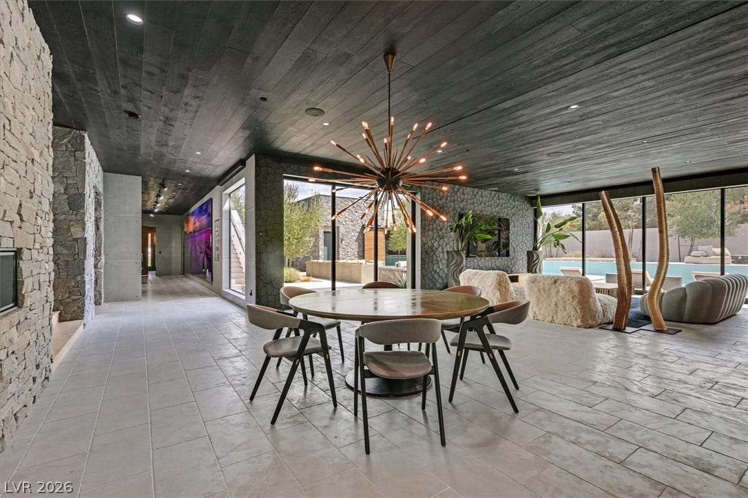 4155 Badura Avenue, Las Vegas, NV 89118 A spacious layout is enhanced by stone accent walls and dark wood paneled ceilings.
