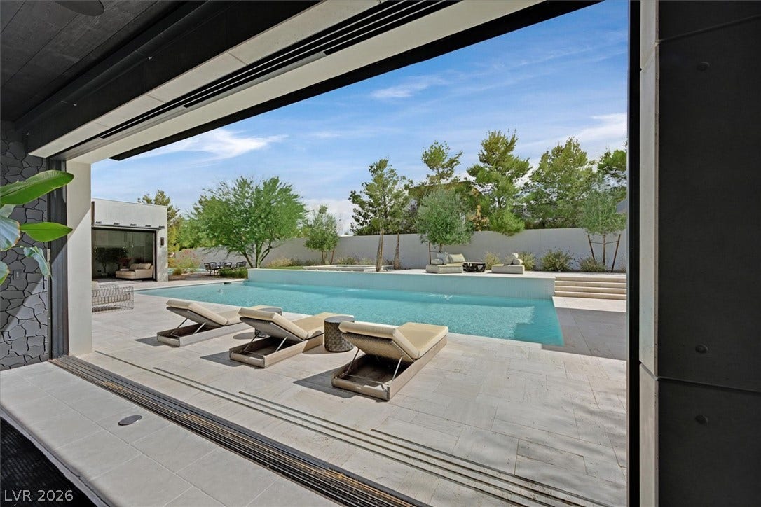 4155 Badura Avenue, Las Vegas, NV 89118 Seamless indoor-outdoor integration yields immediate access to a pristine swimming pool and stone patio.