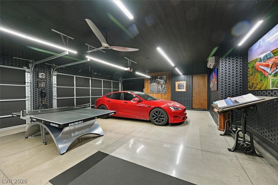 4155 Badura Avenue, Las Vegas, NV 89118 Polished concrete flooring and modern linear lighting define this stylish multi-car showroom garage.